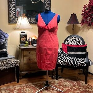 Coral V neck dress with slender shoulder straps.